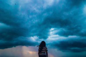 girl watching stormy sky